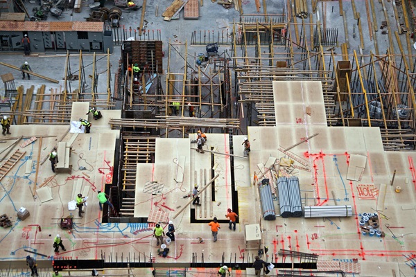 Aerial view of men and materials during construction of a new high-rise apartment building in midtown Manhattan, New York City.